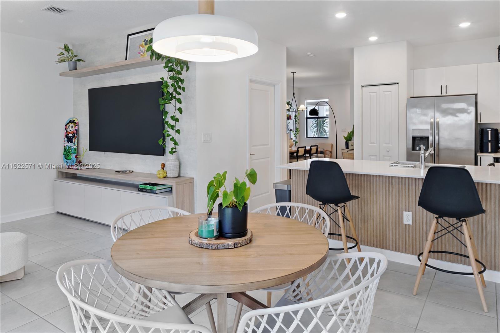 a dining room with furniture and a chandelier