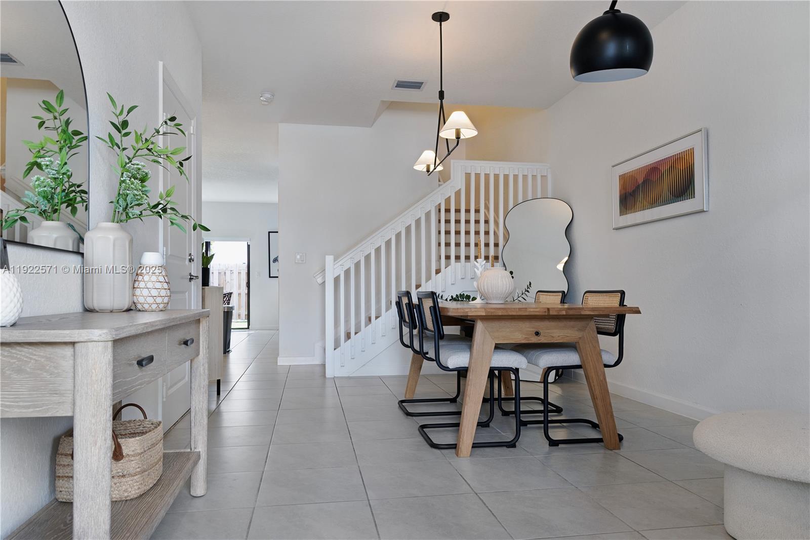 23471 Southwest 129th Path Homestead, FL 33032 - Photo 12 of 52 a view of a dining room with furniture and chandelier