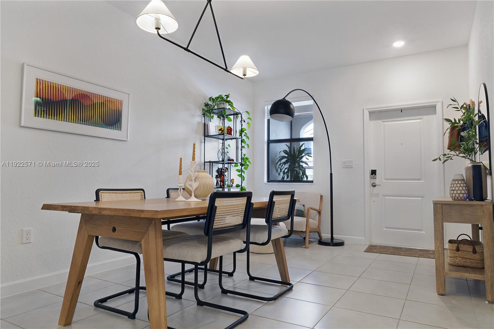 23471 Southwest 129th Path Homestead, FL 33032 - Photo 14 of 52 a view of a dining room with furniture and a potted plant