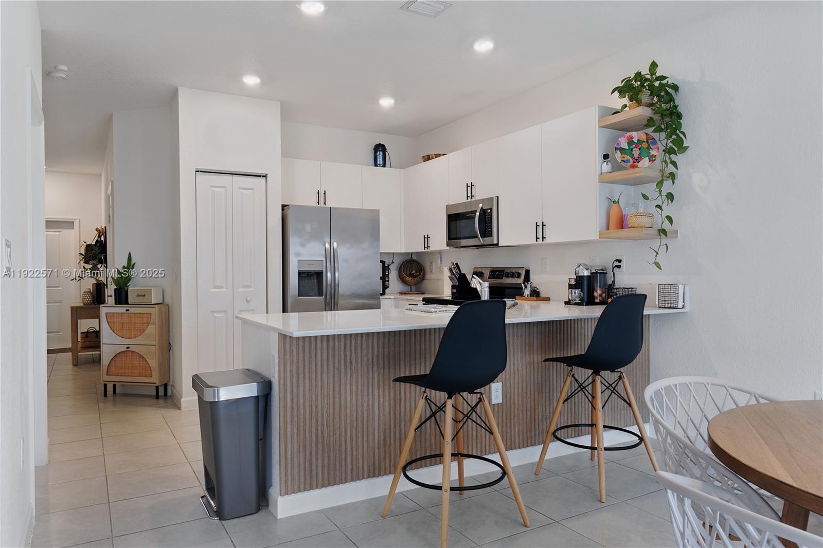 23471 Southwest 129th Path Homestead, FL 33032 - Photo 19 of 52 a kitchen with stainless steel appliances granite countertop a refrigerator and a stove top oven