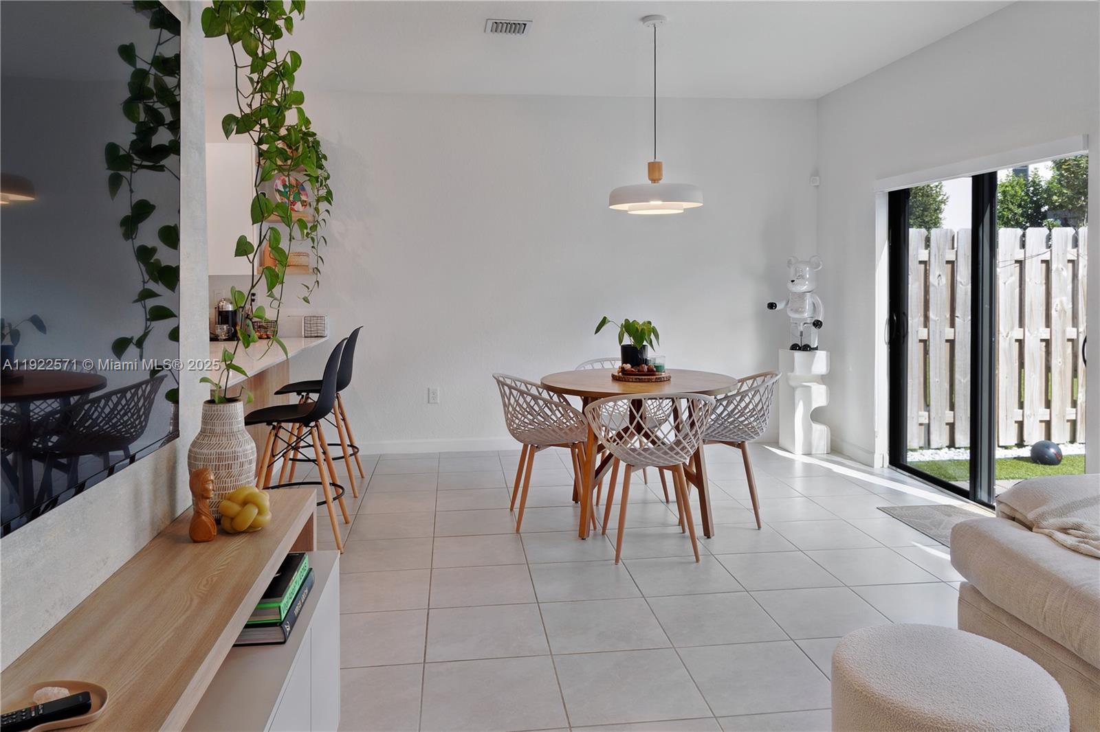 23471 Southwest 129th Path Homestead, FL 33032 - Photo 21 of 52 a view of a dining room with furniture and a potted plant