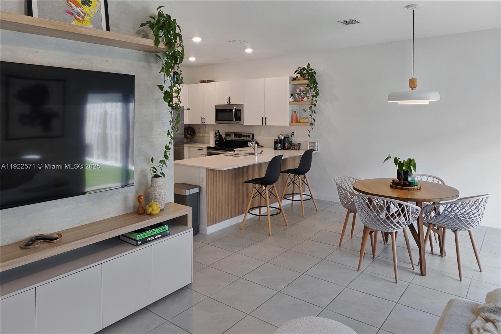 23471 Southwest 129th Path Homestead, FL 33032 - Photo 22 of 52 a kitchen with a table and chairs in it