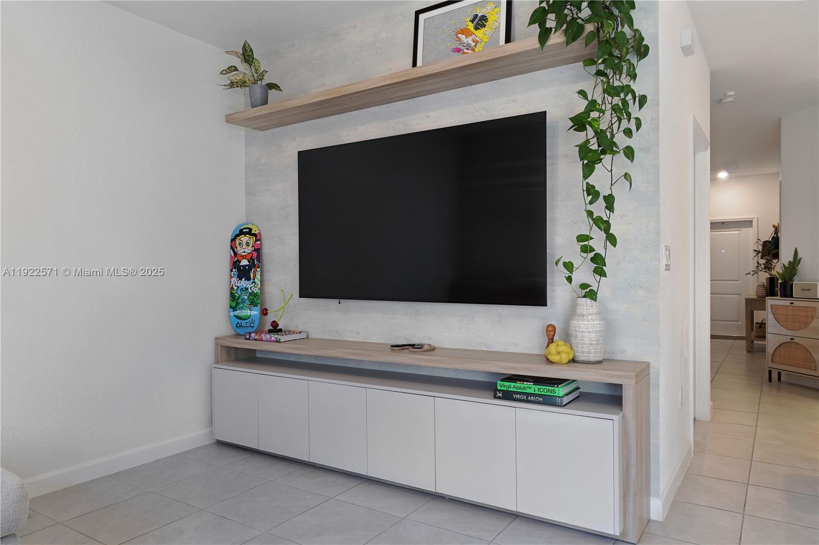 23471 Southwest 129th Path Homestead, FL 33032 - Photo 23 of 52 a living room with a potted plant on a fireplace