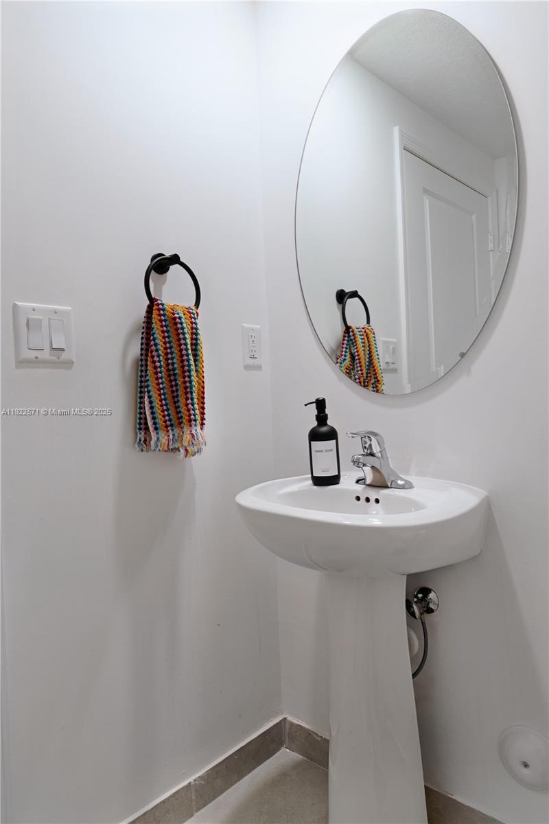 23471 Southwest 129th Path Homestead, FL 33032 - Photo 24 of 52 a bathroom with a sink and mirror