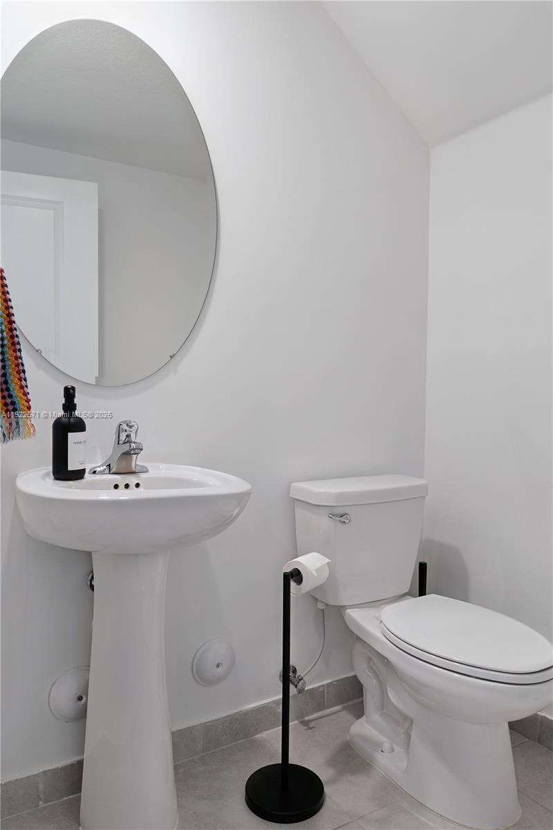 23471 Southwest 129th Path Homestead, FL 33032 - Photo 25 of 52 a bathroom with a sink a toilet and a mirror