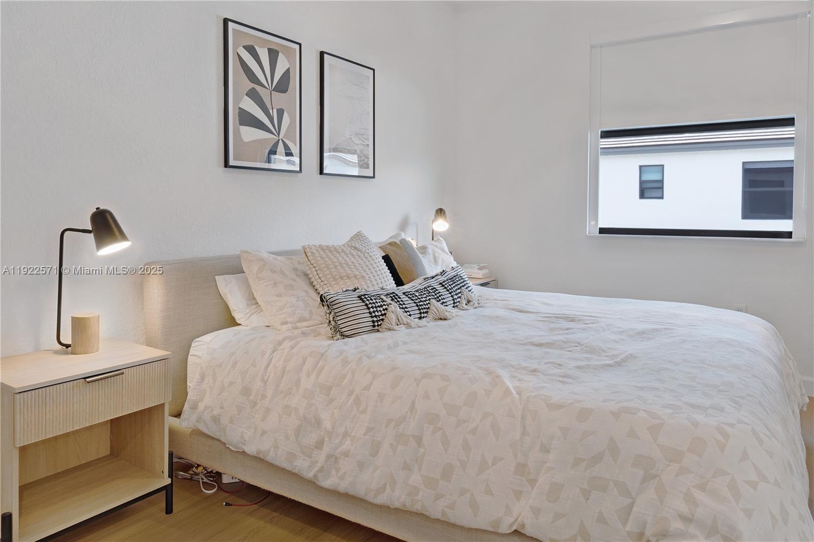 23471 Southwest 129th Path Homestead, FL 33032 - Photo 33 of 52 a bedroom with a bed and night stand