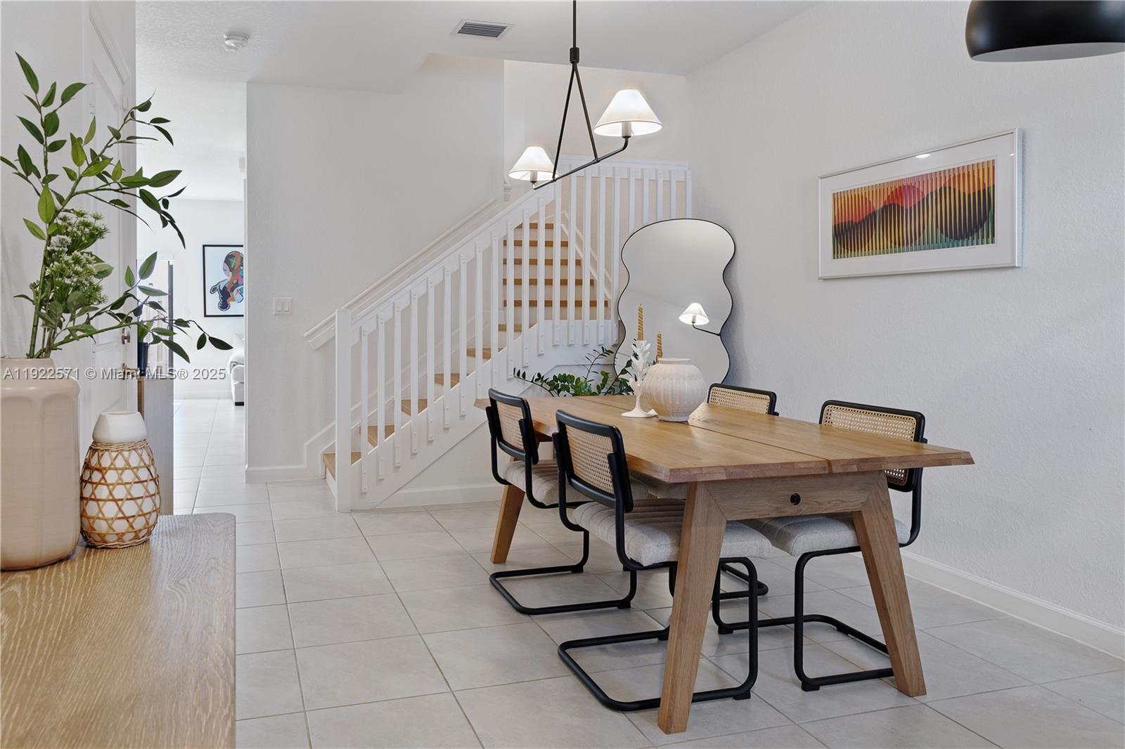 23471 Southwest 129th Path Homestead, FL 33032 - Photo 4 of 52 a view of a dining room with furniture and wooden floor