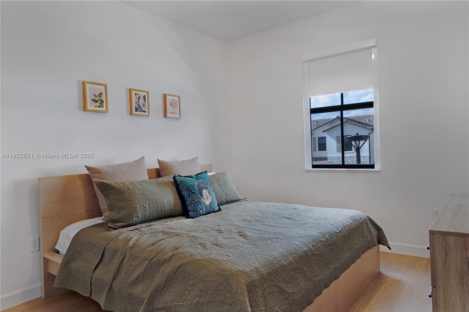 23471 Southwest 129th Path Homestead, FL 33032 - Photo 45 of 52 a bedroom with a bed and a painting on the wall