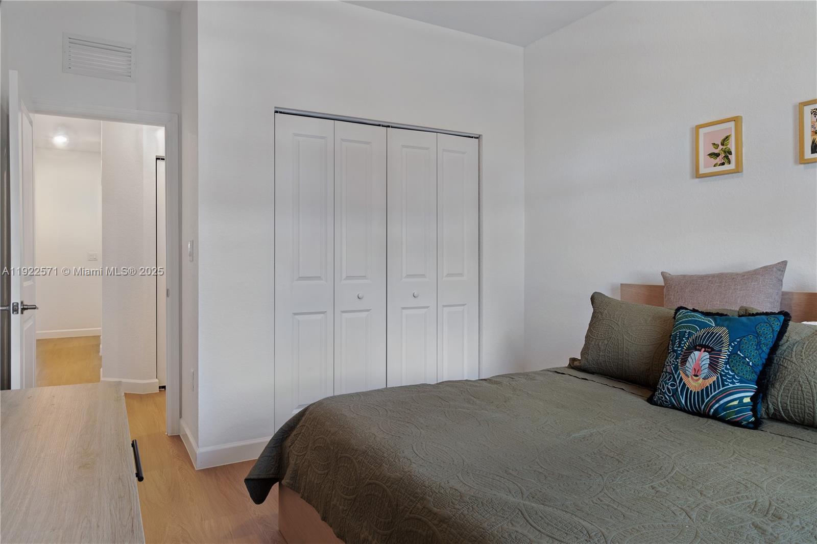 23471 Southwest 129th Path Homestead, FL 33032 - Photo 46 of 52 a bedroom with a bed and cabinets