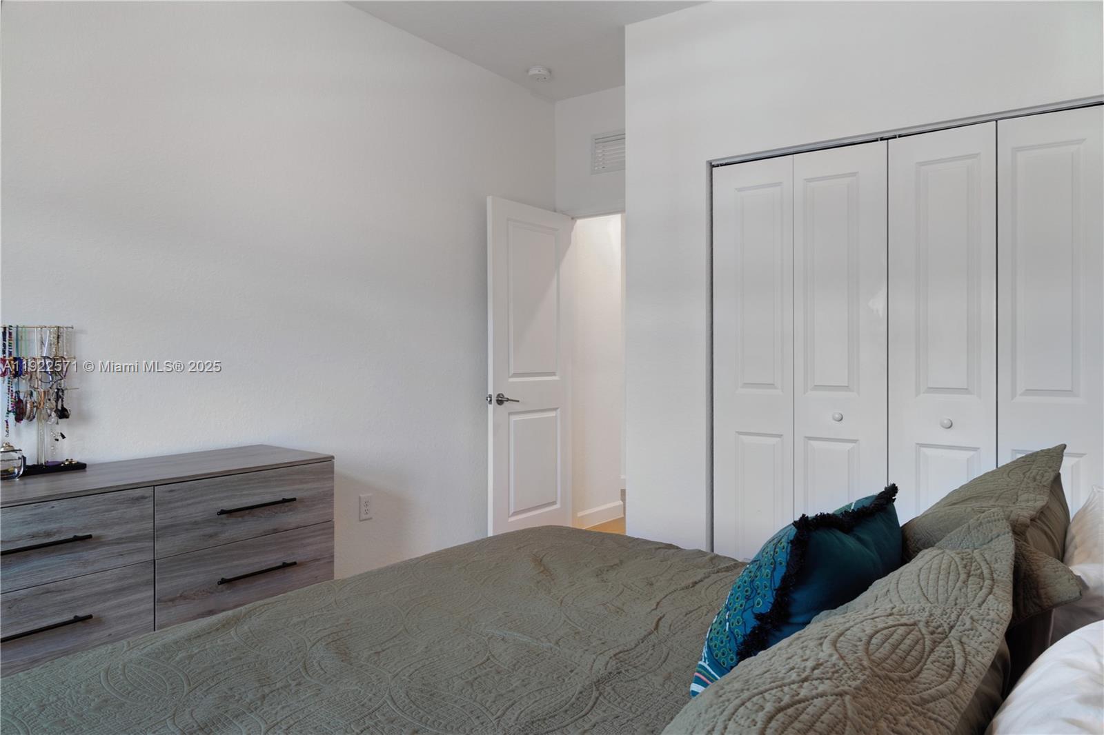 23471 Southwest 129th Path Homestead, FL 33032 - Photo 47 of 52 a bedroom with a bed and a cabinet