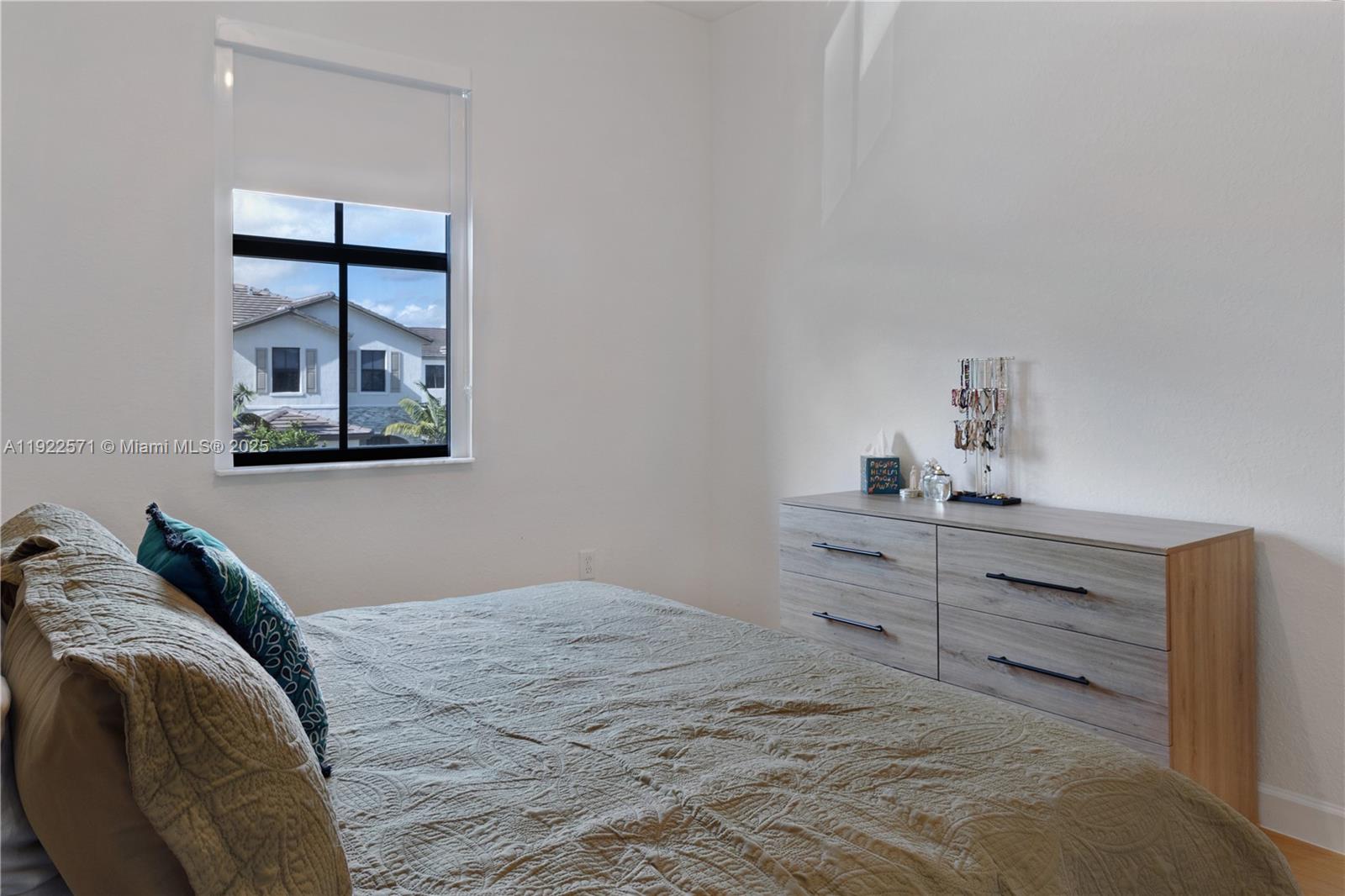 23471 Southwest 129th Path Homestead, FL 33032 - Photo 48 of 52 a bedroom with a bed and a window