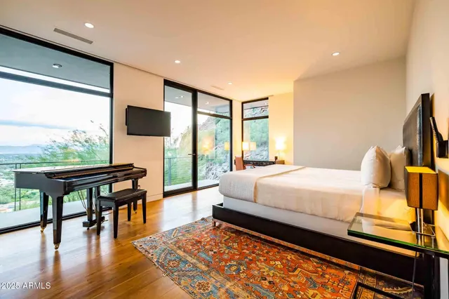 a bedroom with a bed and a flat screen tv