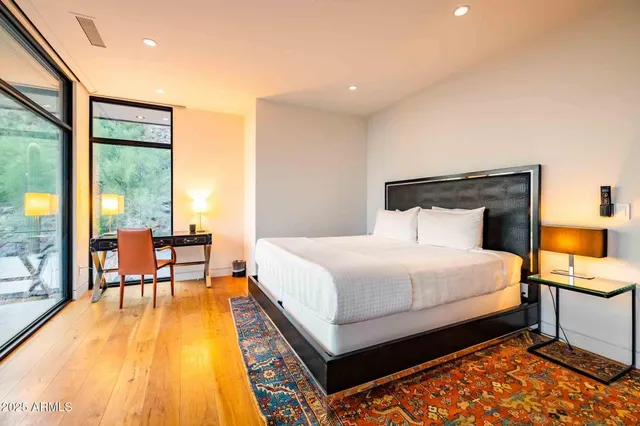 a bedroom with a bed and wooden floor