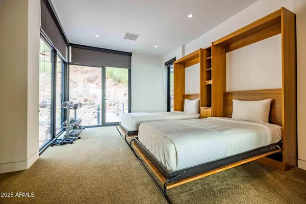 a bedroom with a large bed and a large window