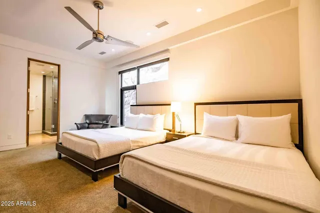 a bedroom with two beds and a chandelier