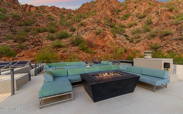 a view of a patio with couches and a fire pit
