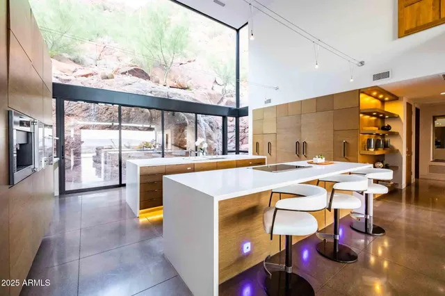 an open kitchen with a table and chairs