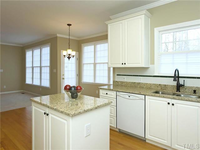 2604 Westmill Court Raleigh, NC 27613 - Photo 13 of 25 a kitchen with granite countertop white cabinets and a sink