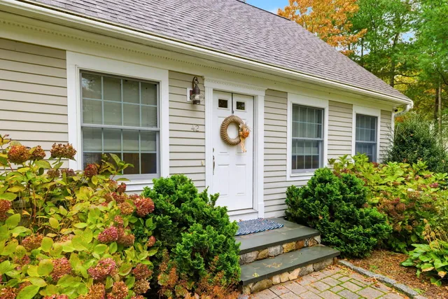 a front view of a house with plants