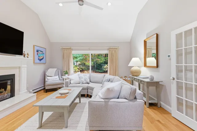 a living room with furniture a flat screen tv and a fireplace