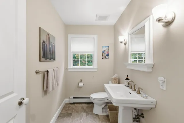 a bathroom with a sink toilet and a mirror