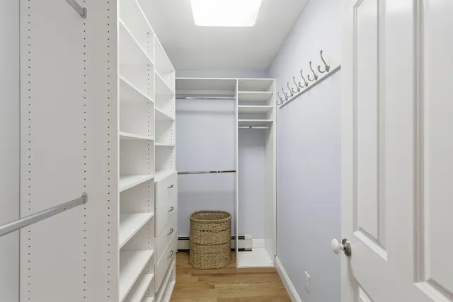 a view of walk in closet with empty racks