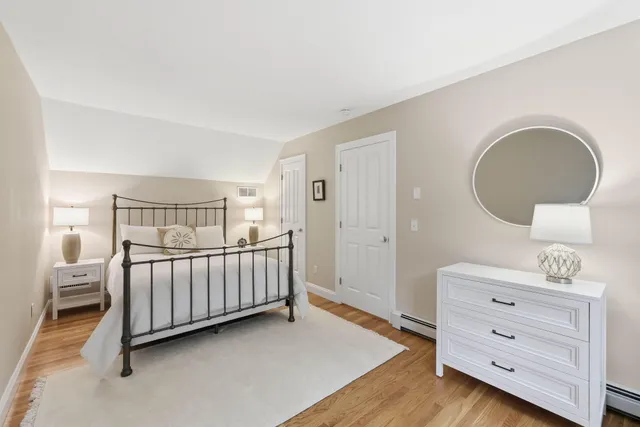 a bedroom with a baby bed dresser and a window