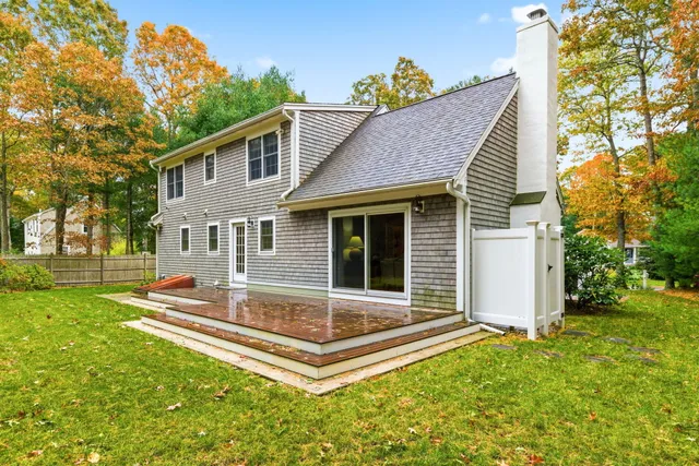 a view of a house with backyard and sitting area