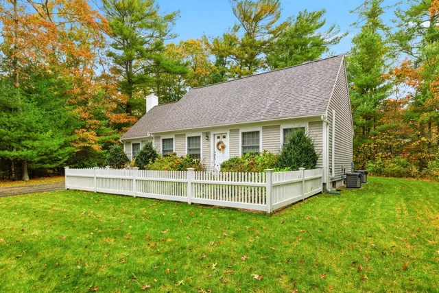 a view of a house with a yard and sitting area