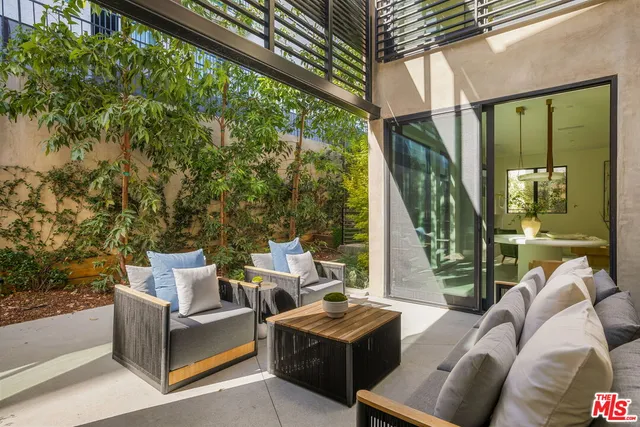 a patio with patio couch and table