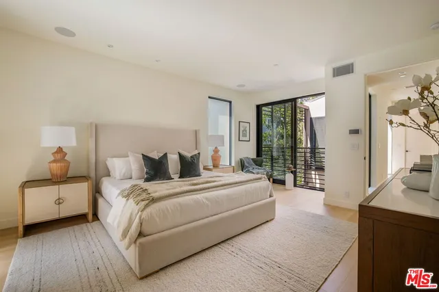 a bedroom with a large bed and a large window