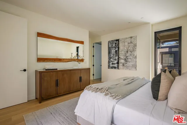 a bedroom with a bed and a mirror