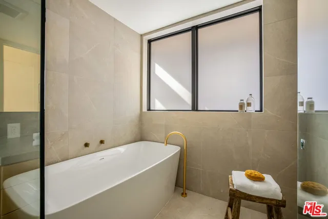 a bathroom with a bathtub and a shower