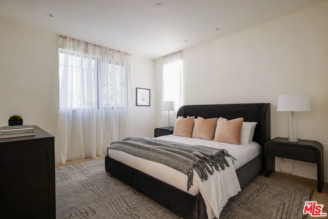 a spacious bedroom with a bed and a window