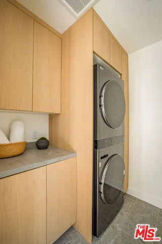 a utility room with sink dryer and washer
