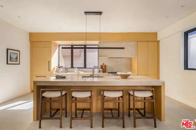 a kitchen with a table and chairs