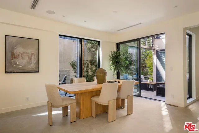 a view of a dining room with furniture large windows and wooden floor