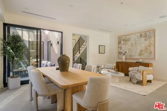 a dining room with furniture and wooden floor