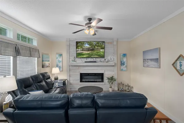a living room with furniture a fireplace and a chandelier