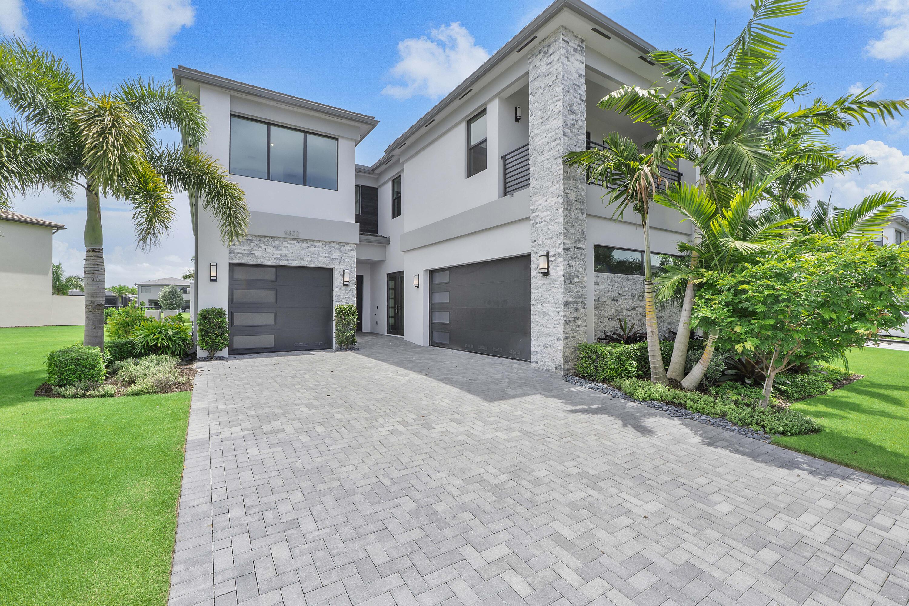 9322 Sunflower Mdw Road Boca Raton, FL 33434 - Photo 2 of 87 a front view of a house with a yard and a garage