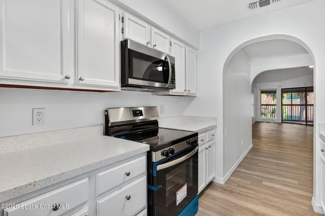 a kitchen with stainless steel appliances a stove microwave and cabinets