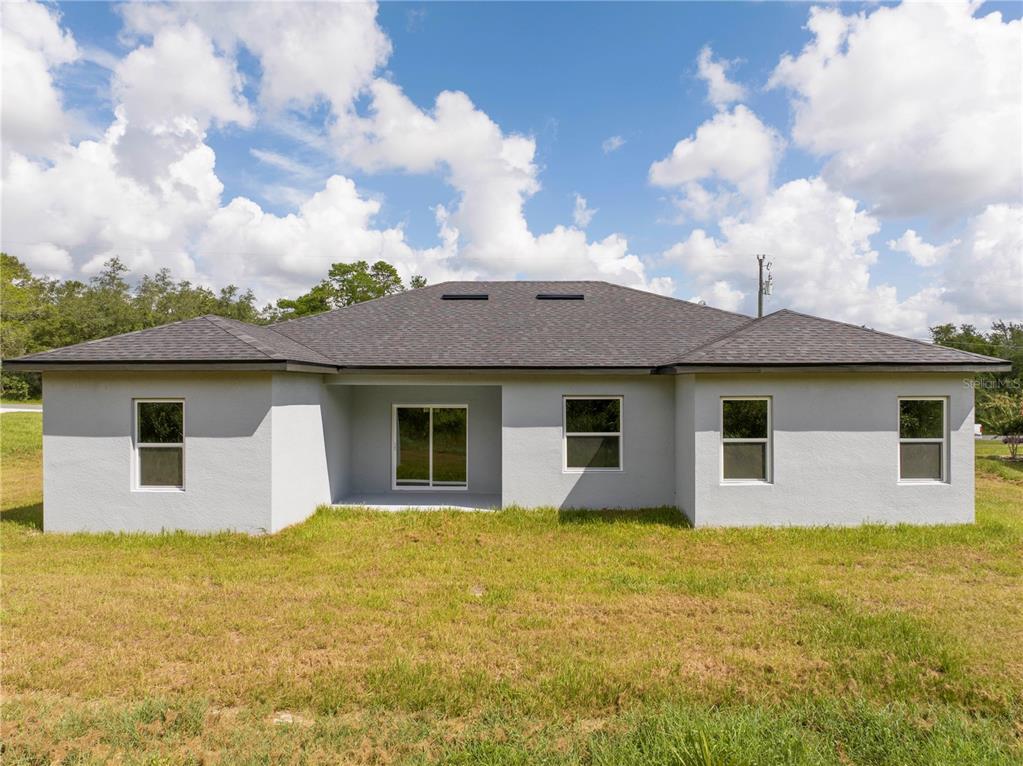 3970 Southwest 157th Place Road Ocala, FL 34473 - Photo 11 of 87 a front view of house with yard and trees in the background