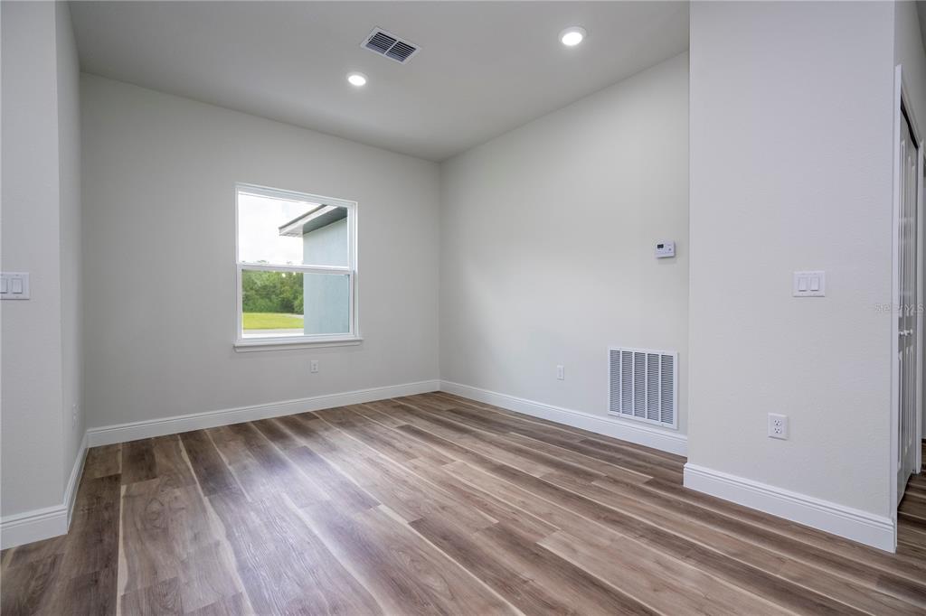 3970 Southwest 157th Place Road Ocala, FL 34473 - Photo 20 of 87 an empty room with wooden floor and windows