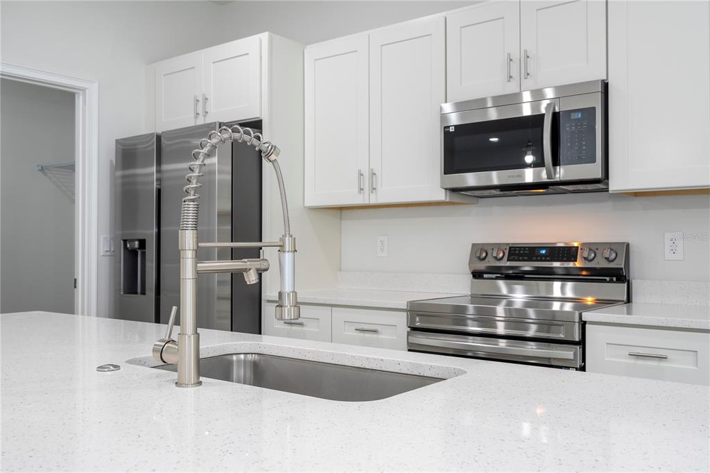 3970 Southwest 157th Place Road Ocala, FL 34473 - Photo 28 of 87 a kitchen with stainless steel appliances granite countertop a refrigerator and a stove top oven