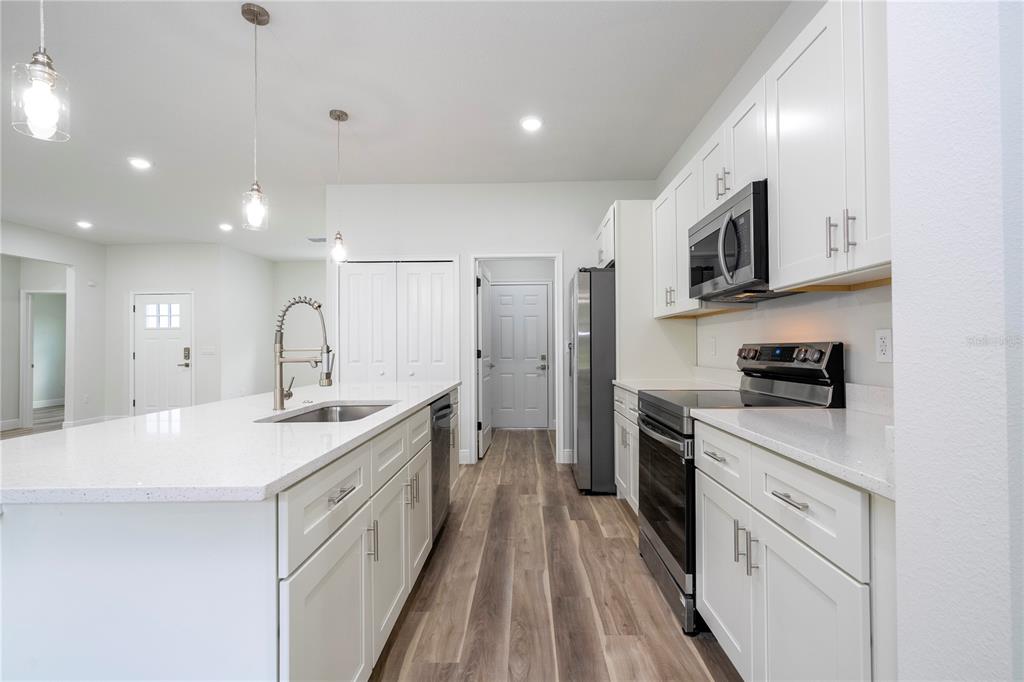 3970 Southwest 157th Place Road Ocala, FL 34473 - Photo 30 of 87 a kitchen with white cabinets appliances and sink