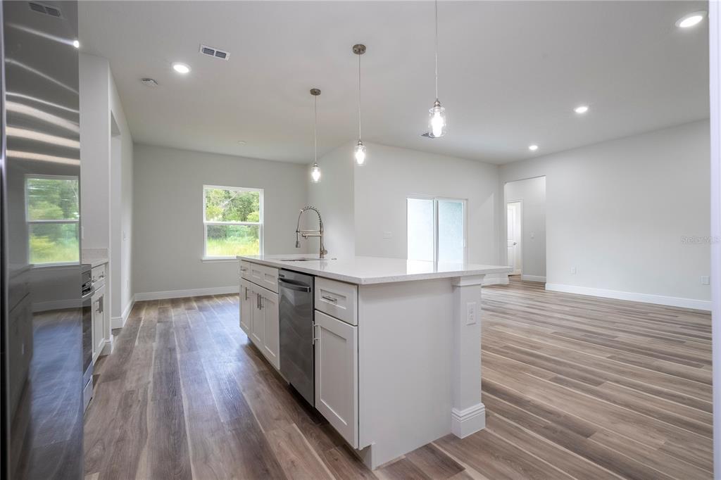 3970 Southwest 157th Place Road Ocala, FL 34473 - Photo 35 of 87 a large kitchen with stainless steel appliances a large counter top a sink and a window