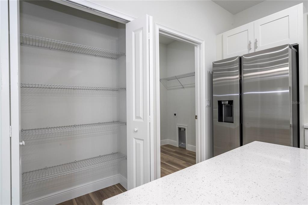 3970 Southwest 157th Place Road Ocala, FL 34473 - Photo 36 of 87 a kitchen with a refrigerator and wooden floor