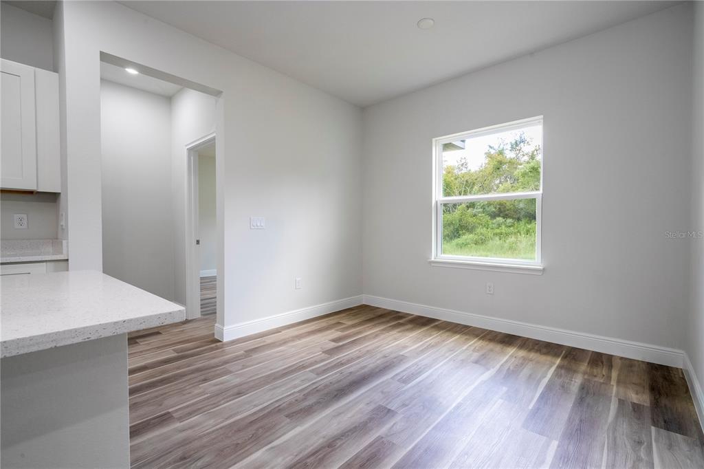 3970 Southwest 157th Place Road Ocala, FL 34473 - Photo 39 of 87 an empty room with wooden floor and windows