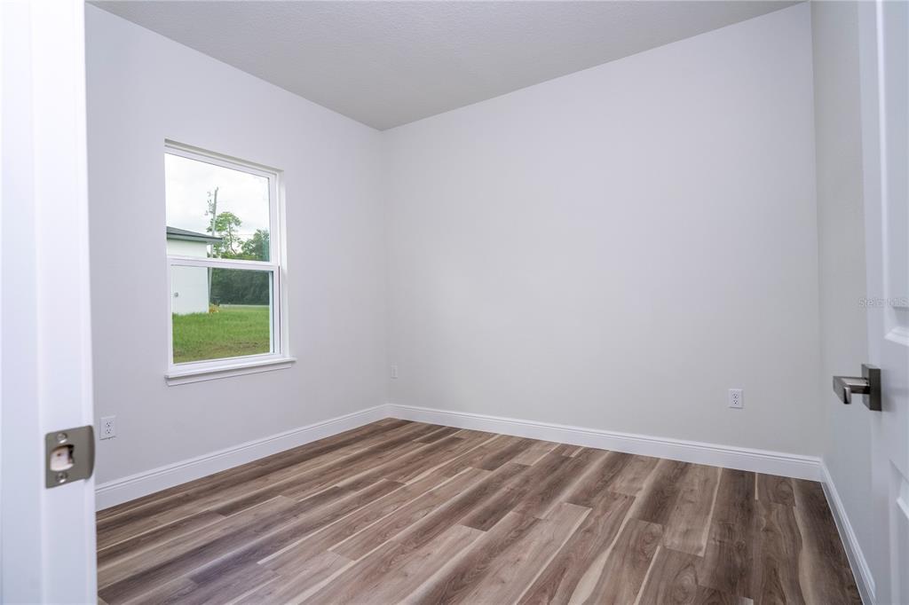 3970 Southwest 157th Place Road Ocala, FL 34473 - Photo 48 of 87 a view of a room that has wooden floor and window in it