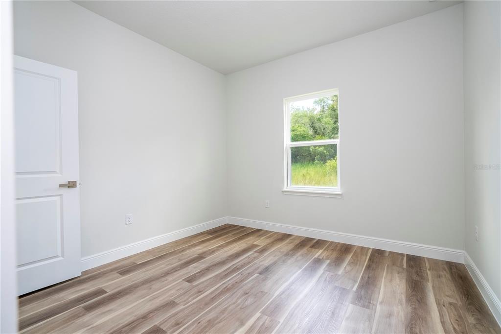 3970 Southwest 157th Place Road Ocala, FL 34473 - Photo 57 of 87 a view of an empty room with wooden floor and a window